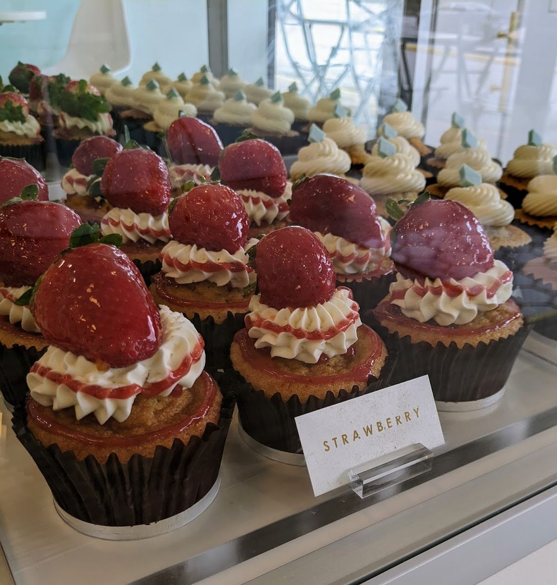 Tray of fresh strawberry cupcakes topped with glazed strawberries at Diamond Dust Cupcakes